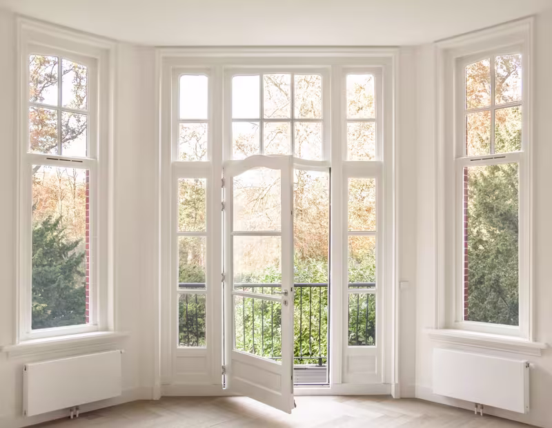 Bright living room featuring a large sliding glass door, showcasing modern design by top window and door manufacturers.