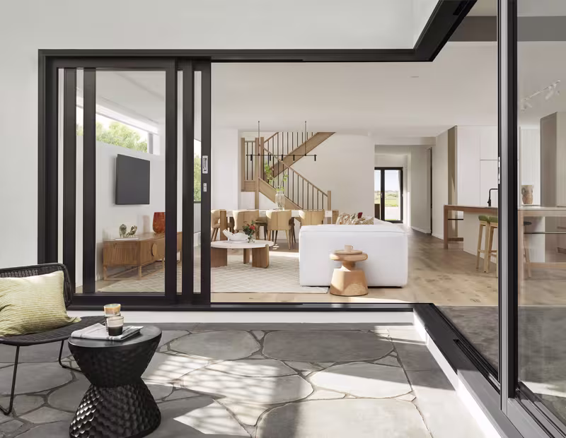Bright living room featuring a large sliding glass door, showcasing modern design by top window and door manufacturers.