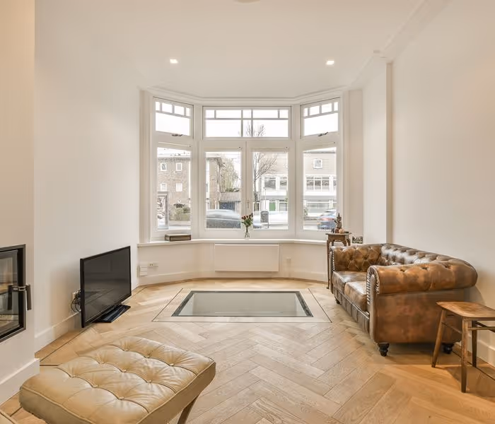 Empty room with hardwood floor and white walls