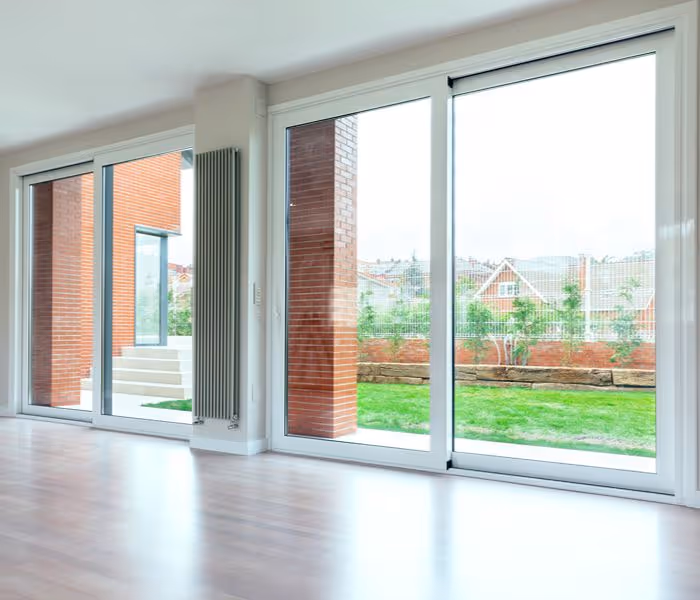 A sleek white uPVC door against a brick wall, ideal for stylish bifold door installation in contemporary homes.