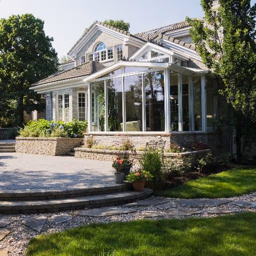Elegant P-shaped conservatory with intricate window designs and white frames