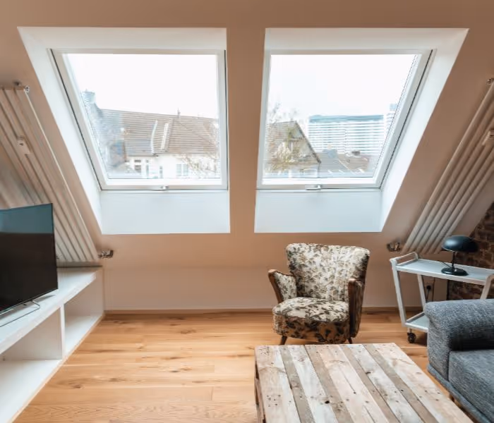 Flat roof with black-framed skylight featuring three double-glazed glass panels