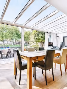 Modern UPVC conservatory with large windows and French doors on a brick base, showcasing upvc doors and windows suppliers.