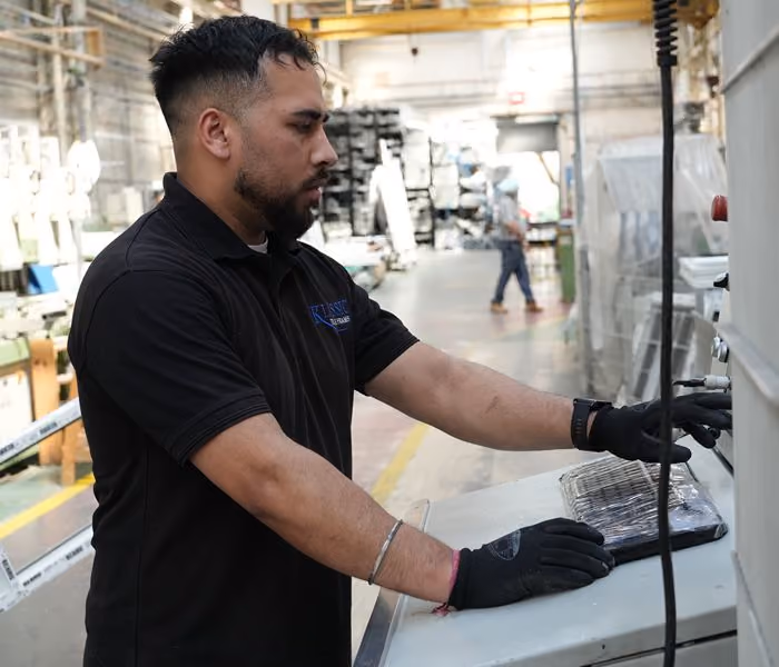Workers in a bright industrial factory with large windows and and productive environment.