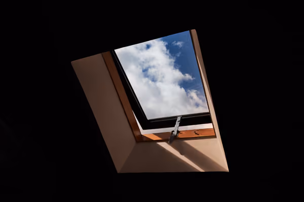 Tall four-pane window overlooking a lush garden