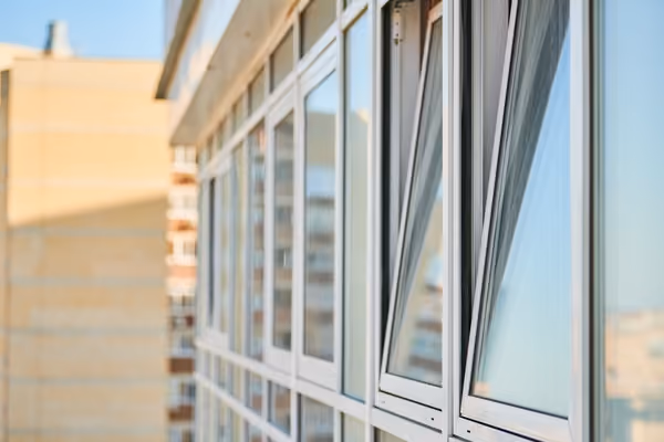 Tall four-pane window overlooking a lush garden
