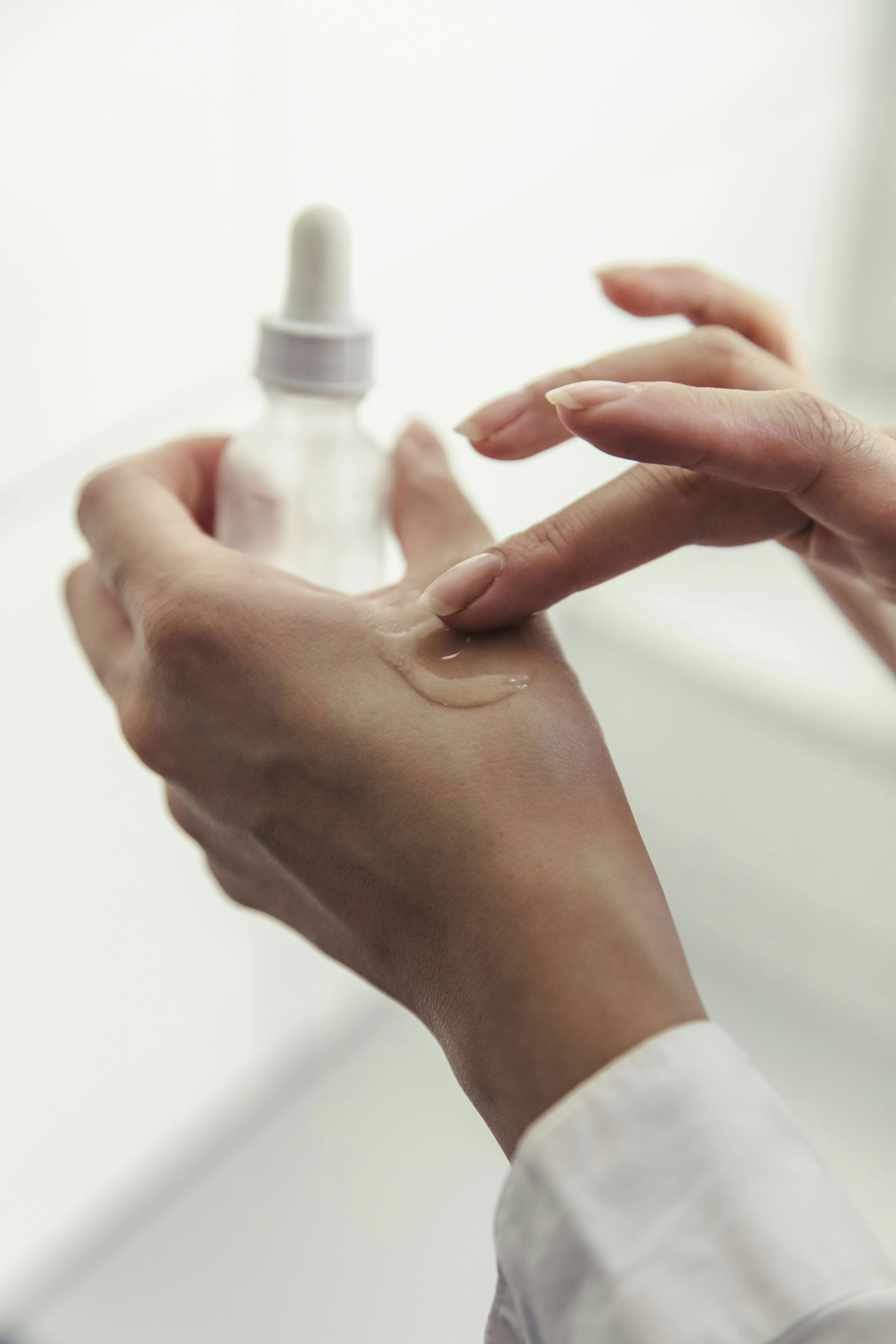 Close-up of Essentika lipid blend droplets in a glass petri dish, illustrating clean-smart formulation workflow and texture evaluation.