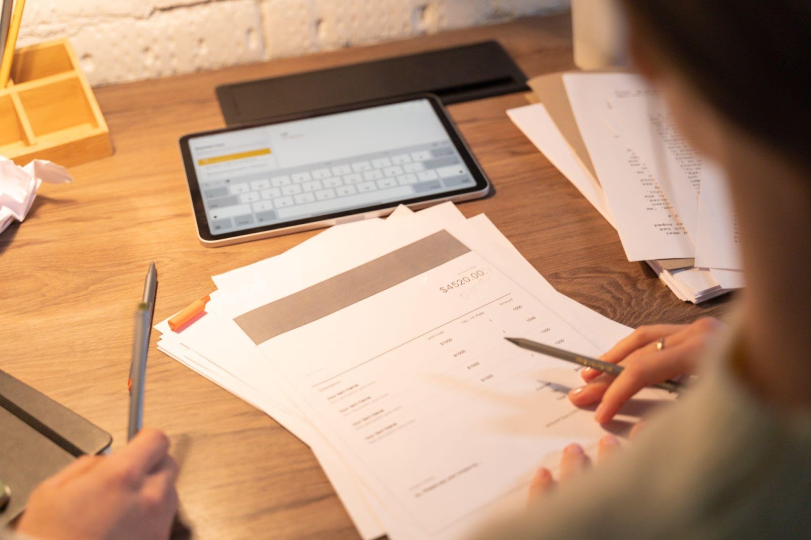 A person analyzing a printed invoice.