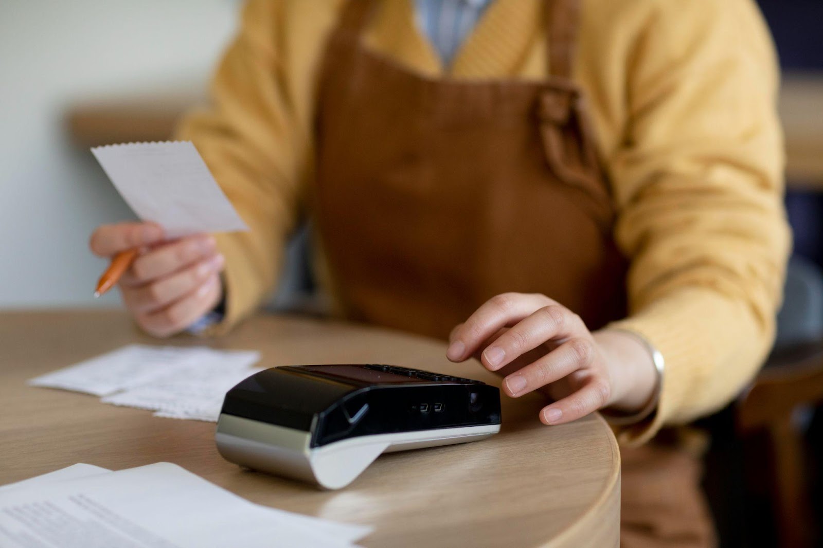 A business owner holding a receipt of payment