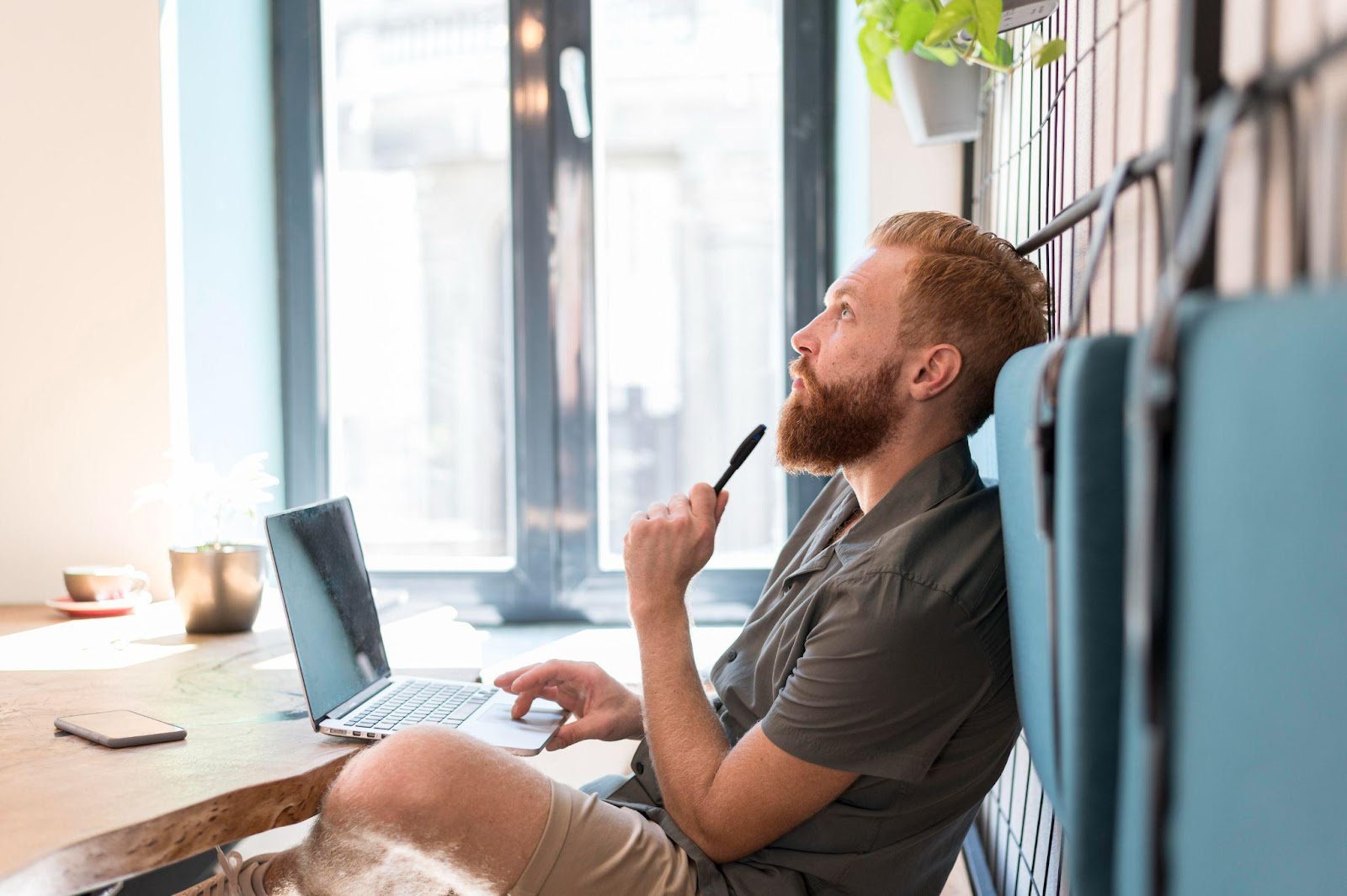 Freelancer thinking and working with a laptop