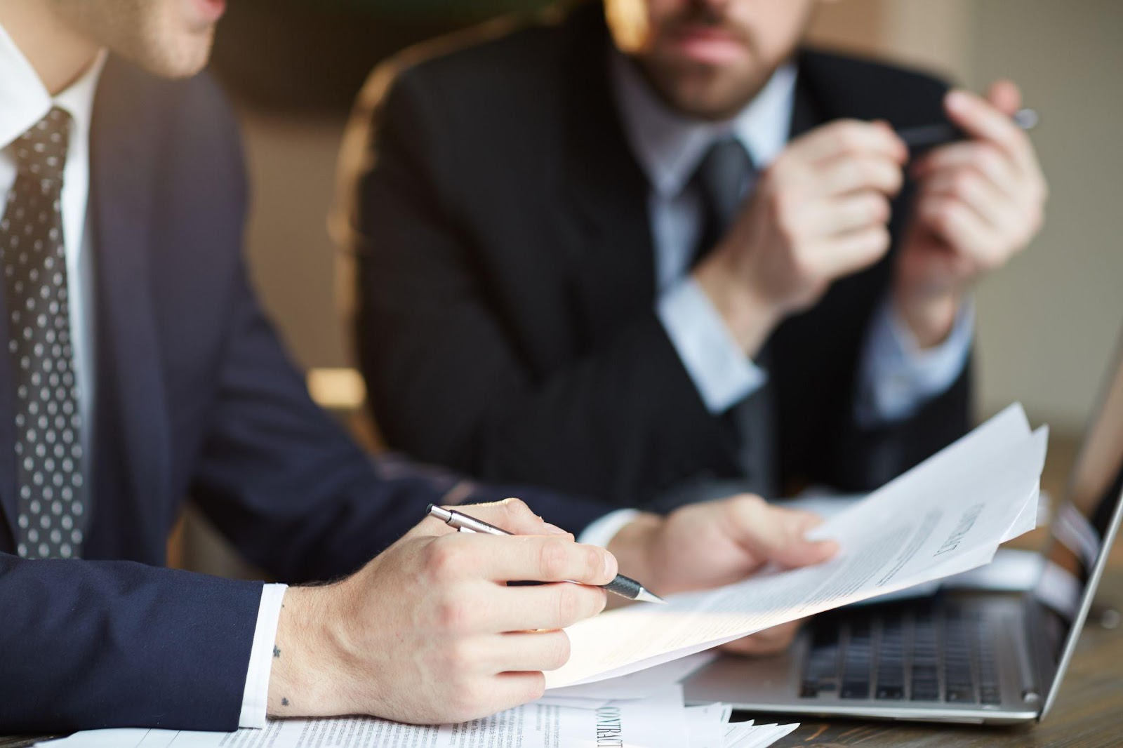 Business partners discussing LLC formation documents.