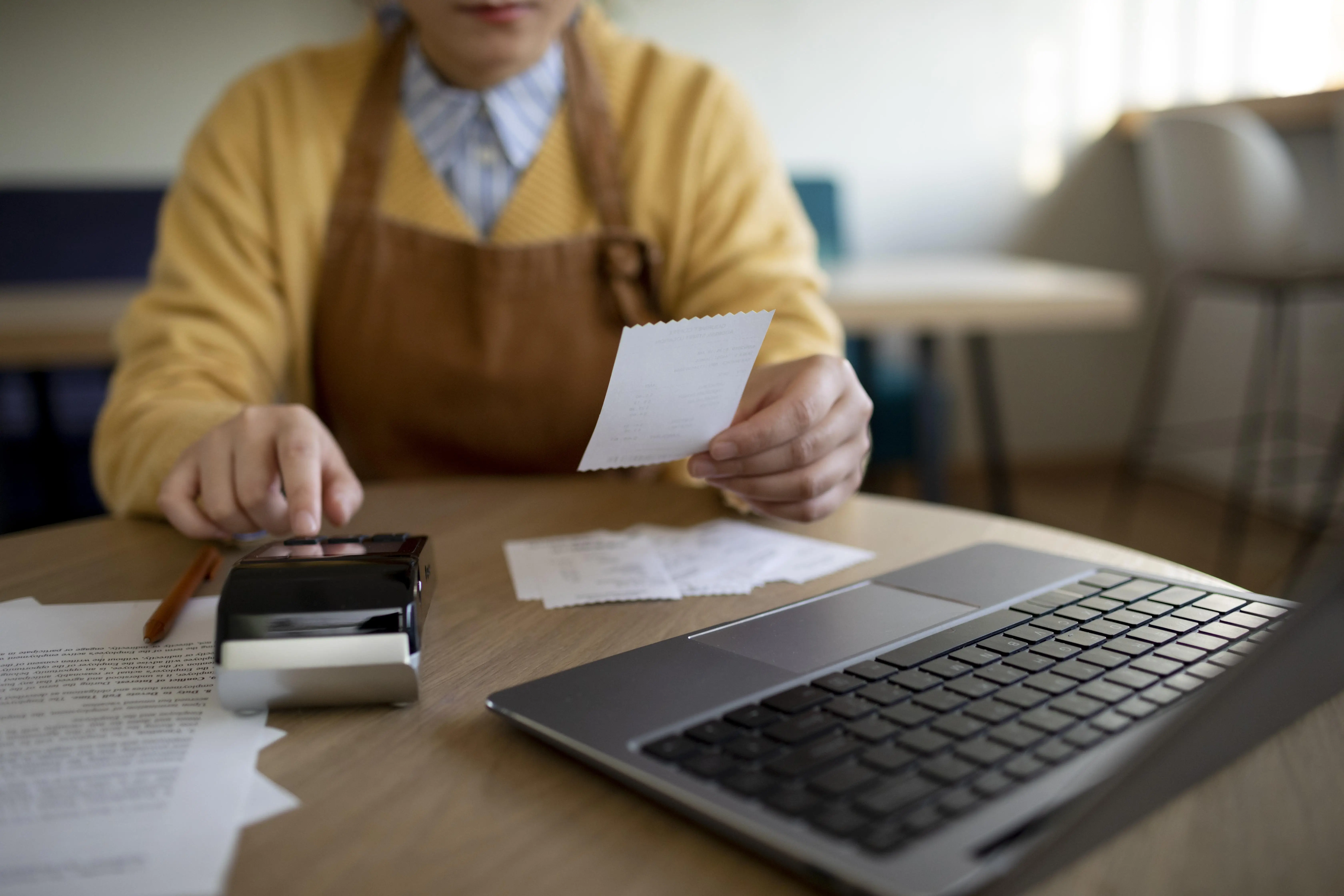 Business owner noting down on a clipboard