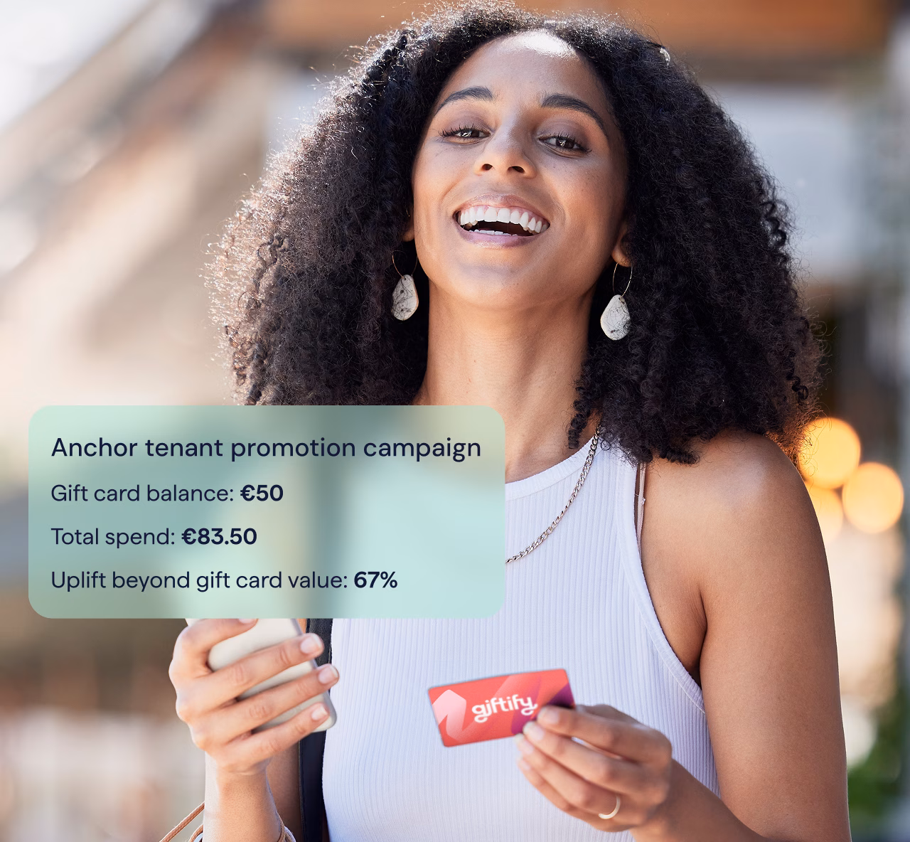 Woman with phone and Giftify card in hand