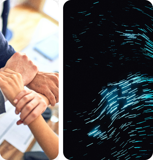 A couple of people holding hands in front of a computer screen.