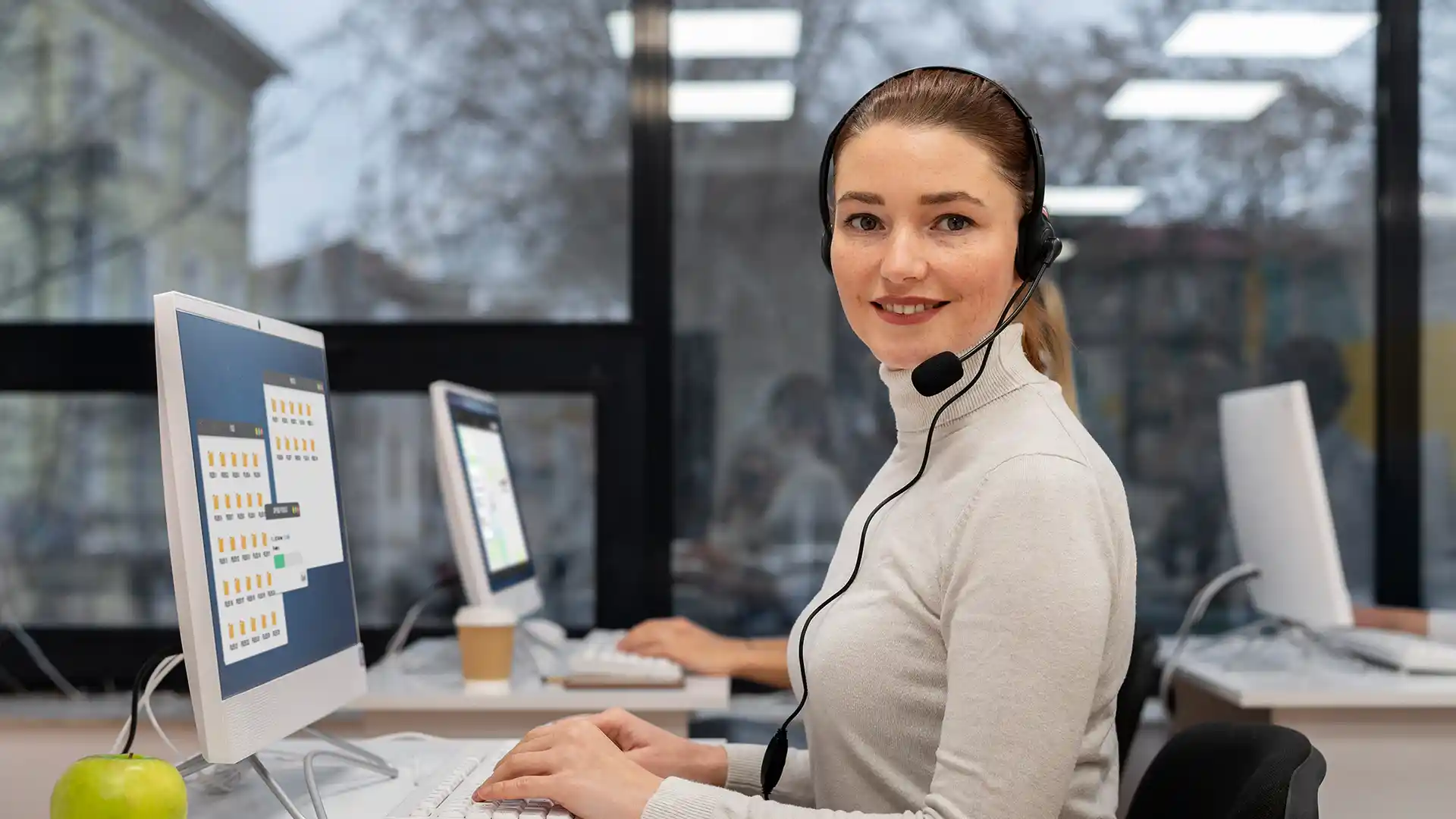 A customer service agent in a traditional call center setting.