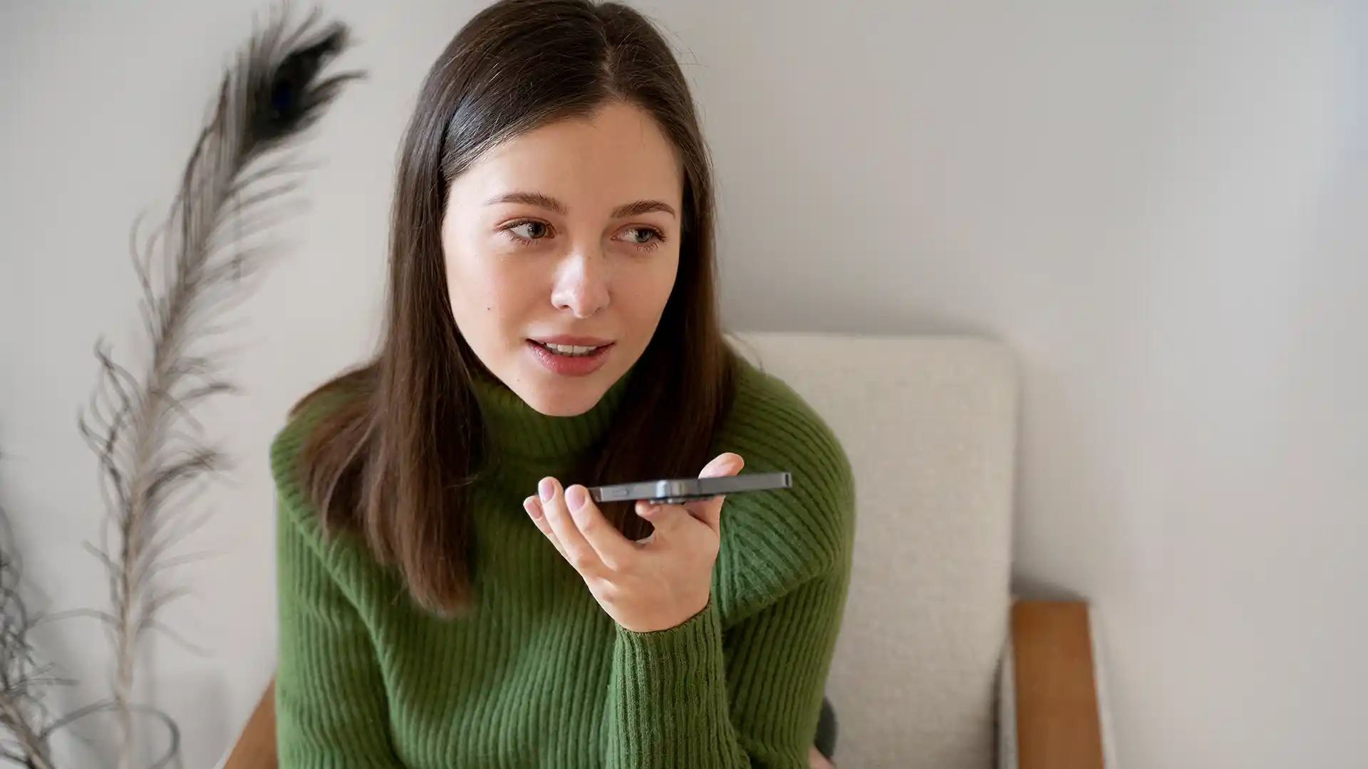 A customer at home, talking on the phone with a voice assistant.