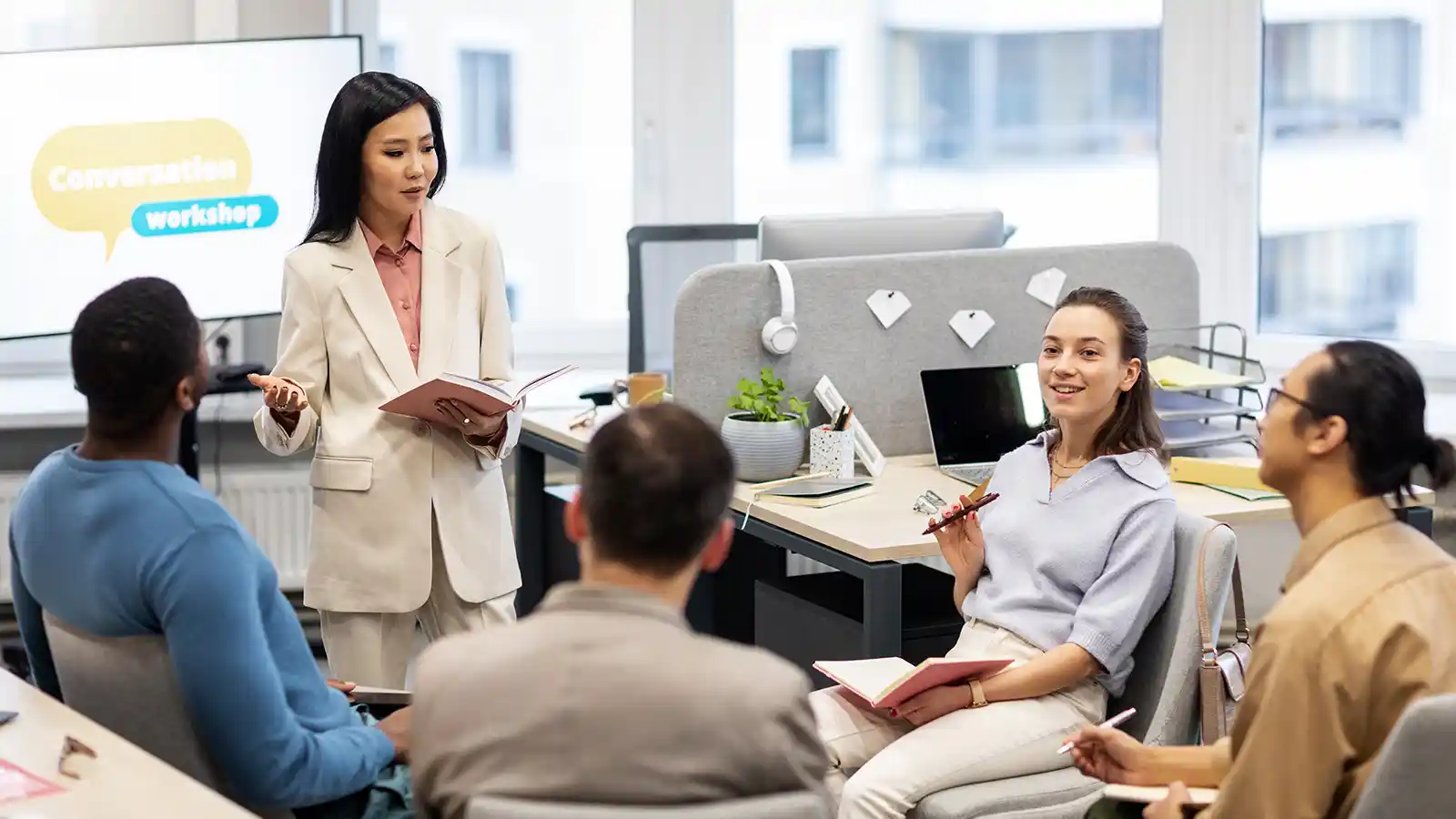 An employee group watching an HR presentation on benefits.
