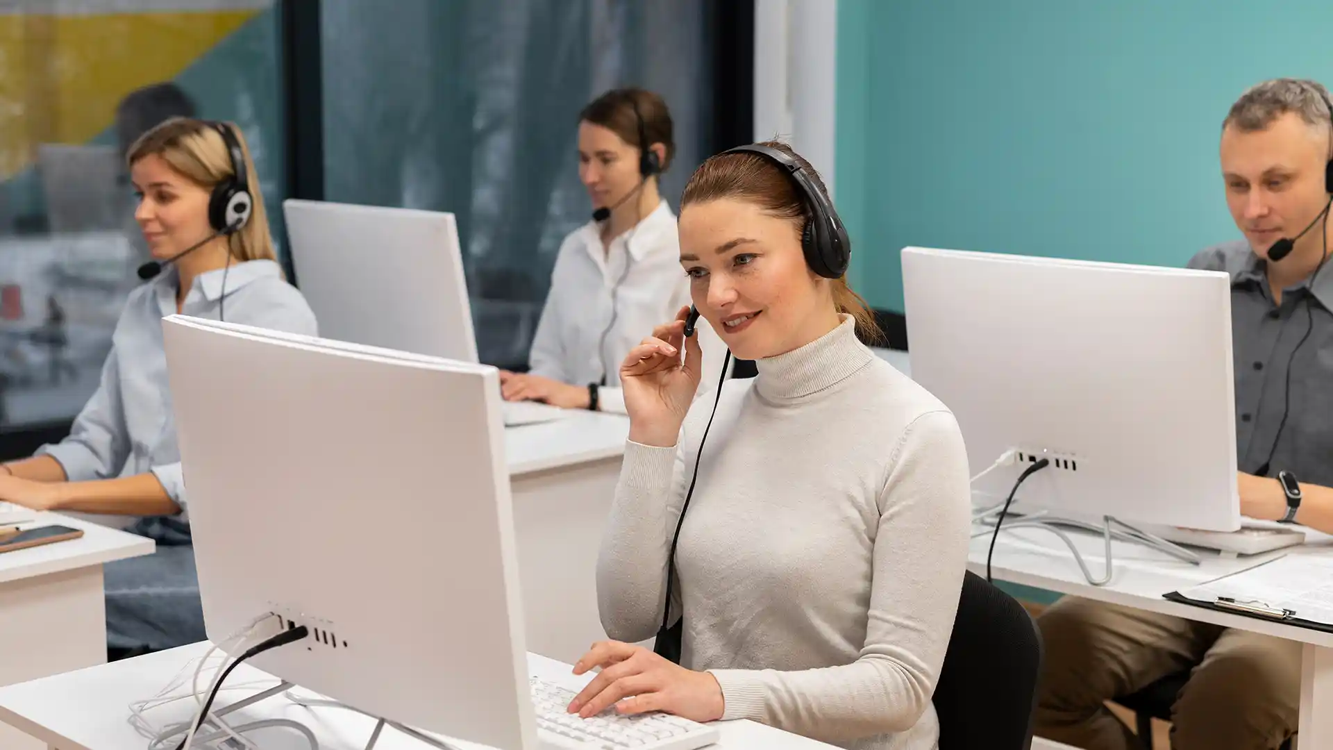 A productive and efficient customer service team at their workstations.