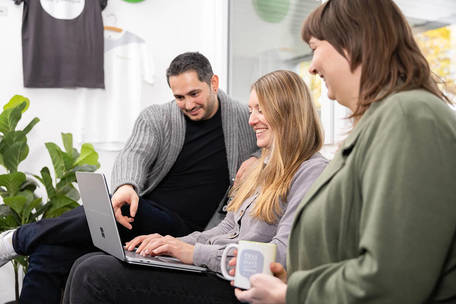 Mehrere Personen schauen gemeinsam auf ein Notebook