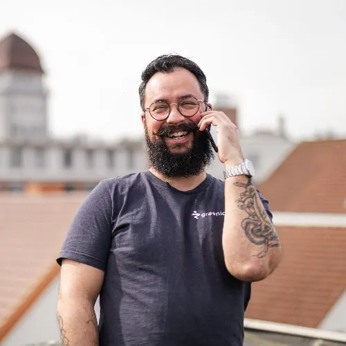 Mann telefoniert vor Häuserdach-Panorama.