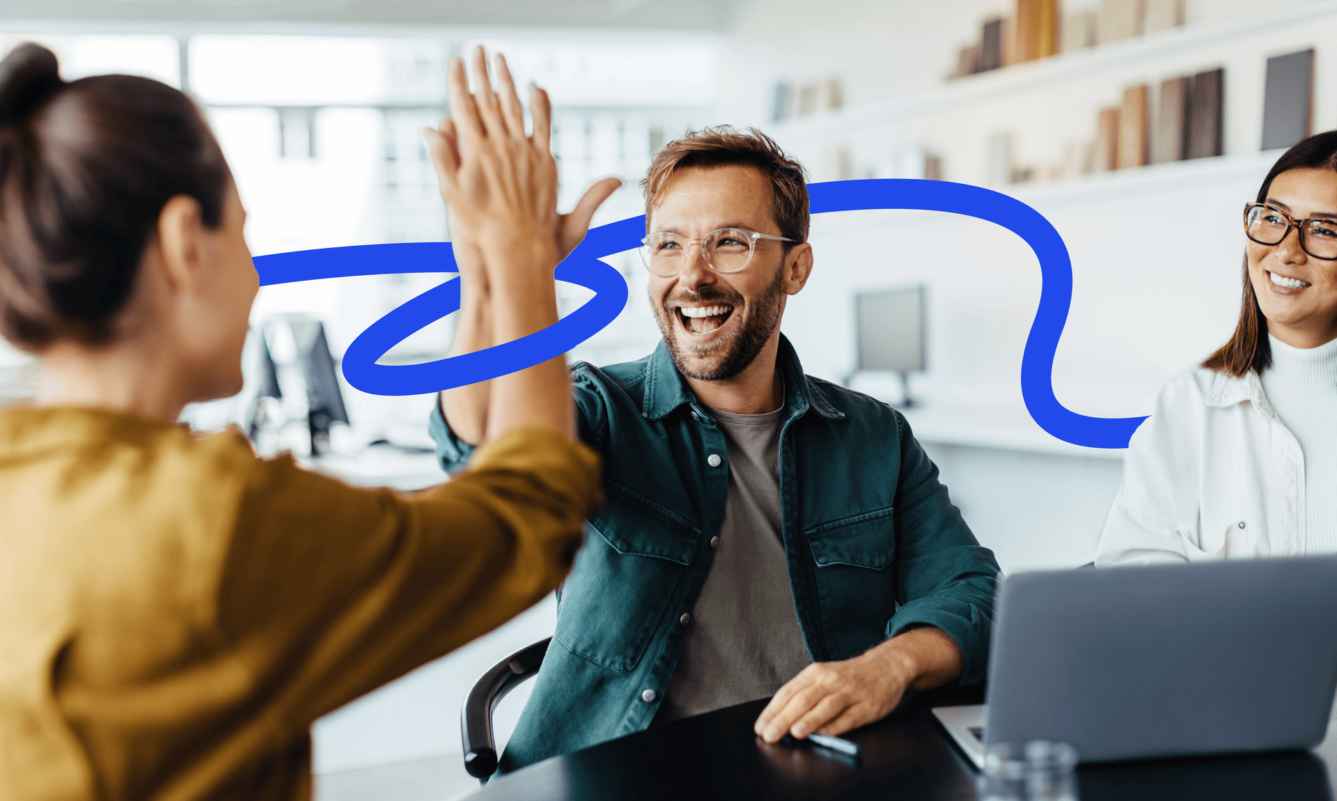 2 people giving a high-five surrounded by a blue graphic as one person watches.