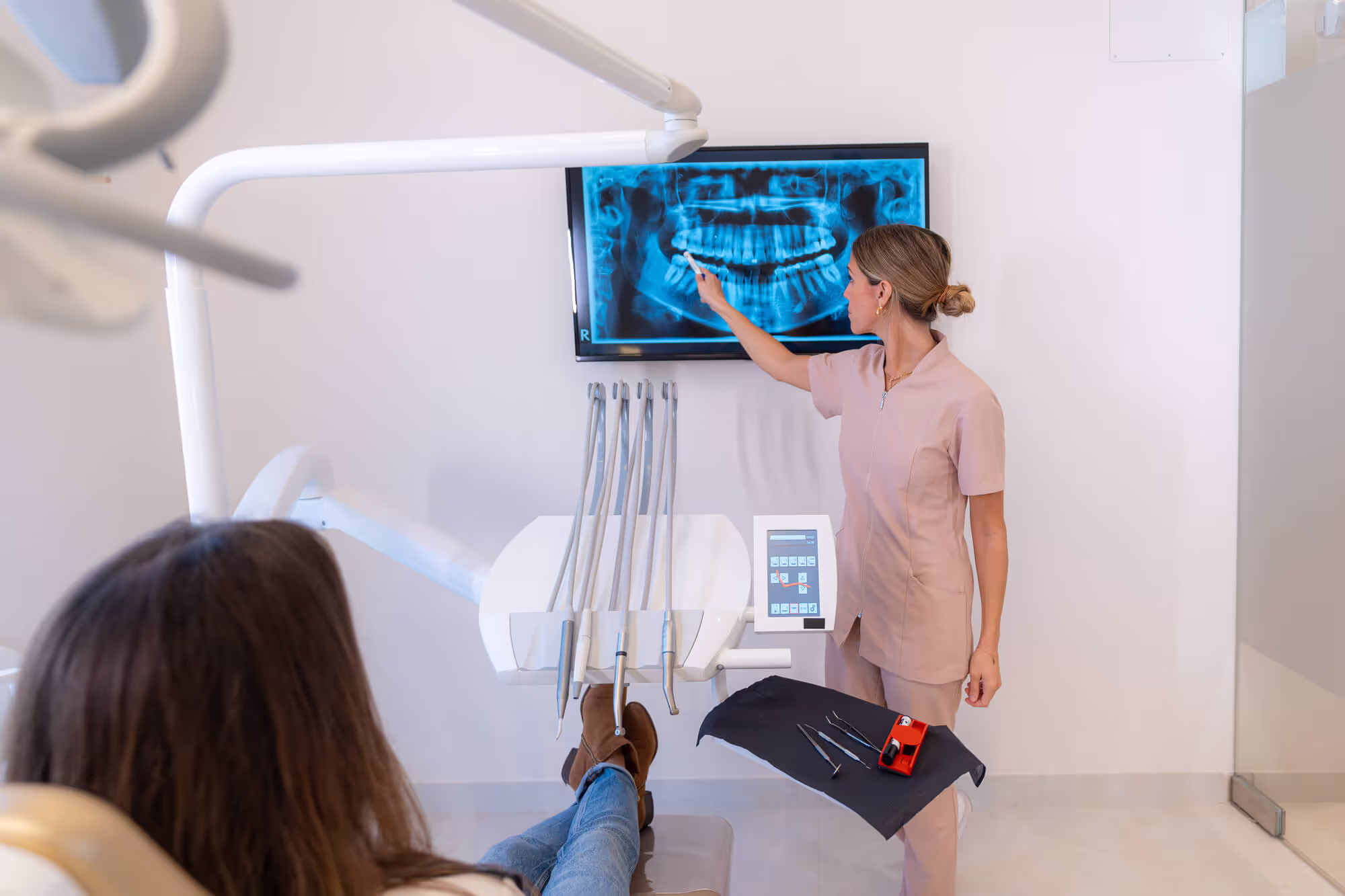 dentist explaining the x-ray image of the patient's teeth