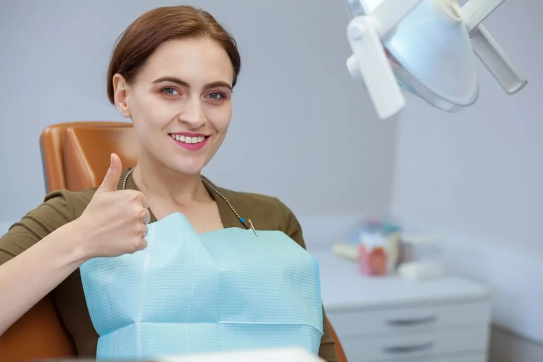 female dental patient approving of the treatment she received