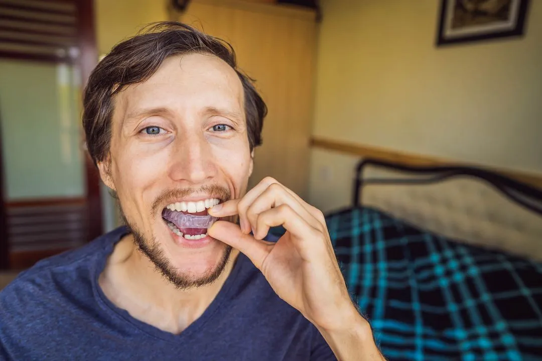 man wearing a night guard before going to bed
