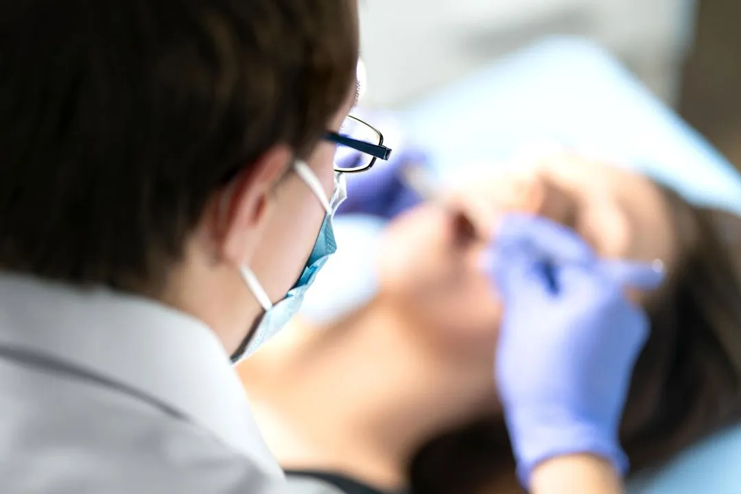 dentist removing an impacted wisdom tooh