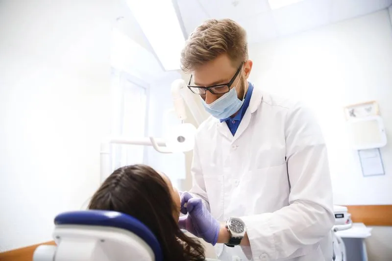 dentist removing an impacted wisdom tooth