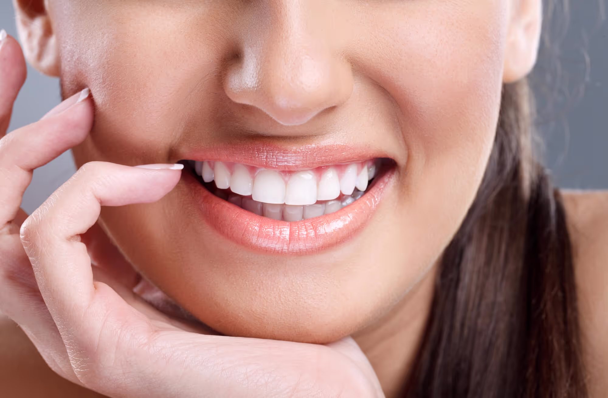 woman showing off her professionally whitened teeth