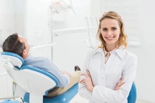 female dentist smiling before attending to a patient