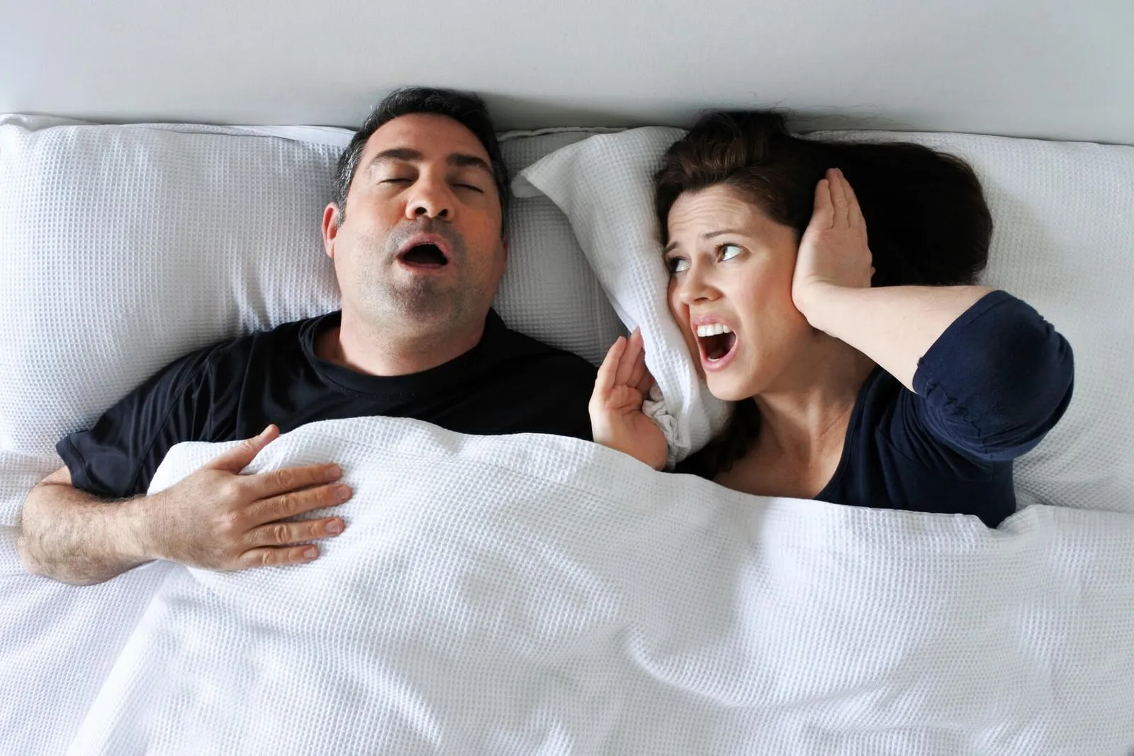 photo of a wife who coudn't sleep because of her husband's loud snoring