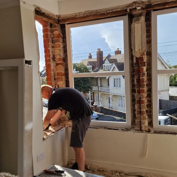 fixing a window picture for customers to see