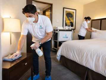 CleanWise Solutions hotel cleaning staff member servicing a guest-facing hotel space with professional commercial cleaning.