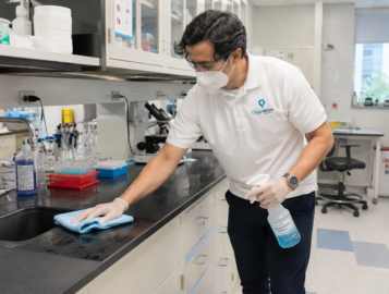 CleanWise Solutions laboratory cleaning professional maintaining a working lab environment.