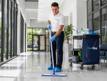 CleanWise Solutions janitorial services team member performing routine cleaning in a commercial facility.