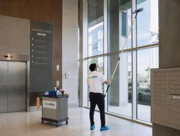 CleanWise Solutions multi-tenant building cleaning professional cleaning high windows in a shared commercial property.