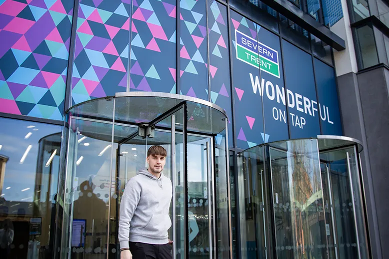 Young person walking out of Severn Trent office