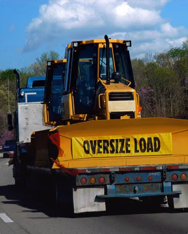 Bulldozer being transported via truck