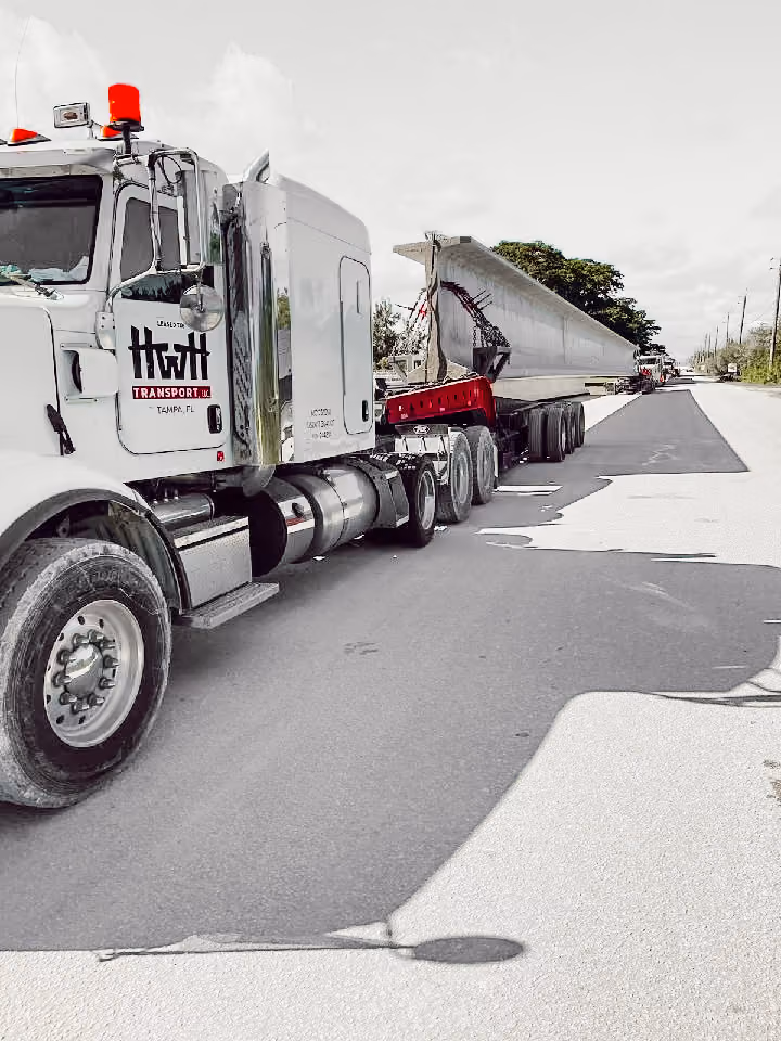 HWH truck transporting a massive concrete beam