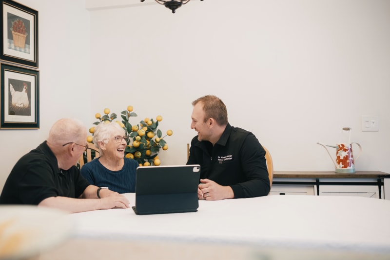 Senior receiving dental examination at home during house call dentistry visit with dentist