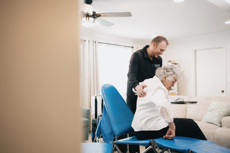 Senior patient smiling in dental chair during home dental examination