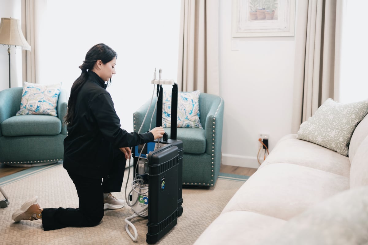 Dentist consulting with elderly patient in home setting, discussing dental care