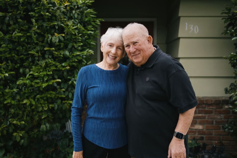 Elderly couple embracing outdoors, showing familial care and connection