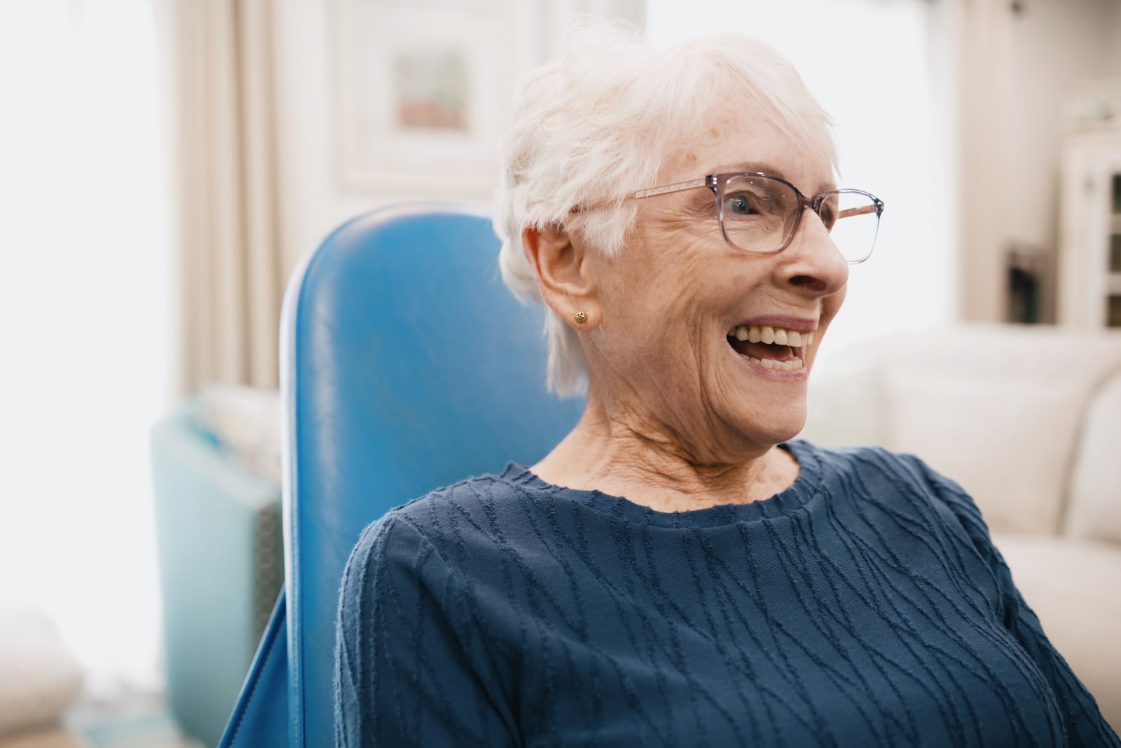 Smiling senior patient in dental chair during treatment at In Motion Dentists