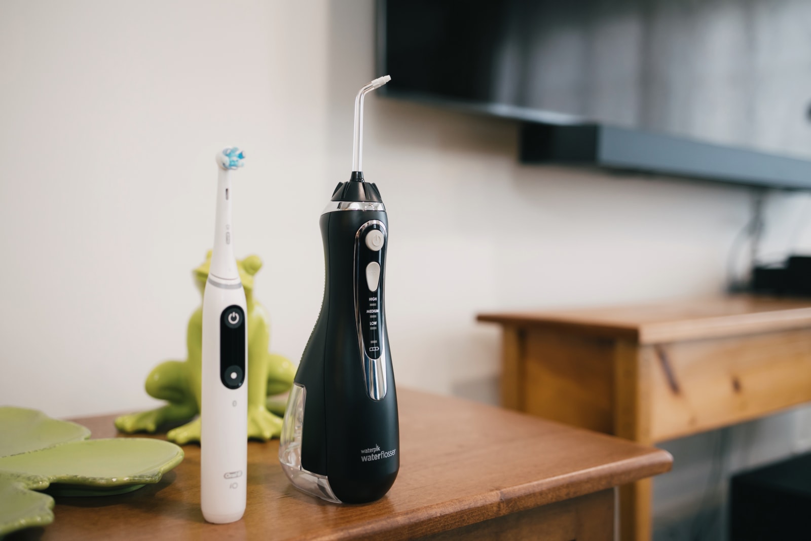 Electric toothbrushes displayed on a wooden surface for oral care education