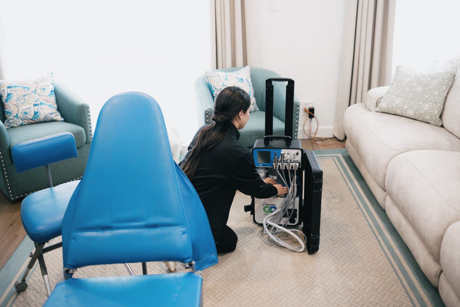Dental provider preparing patient in treatment chair for procedure