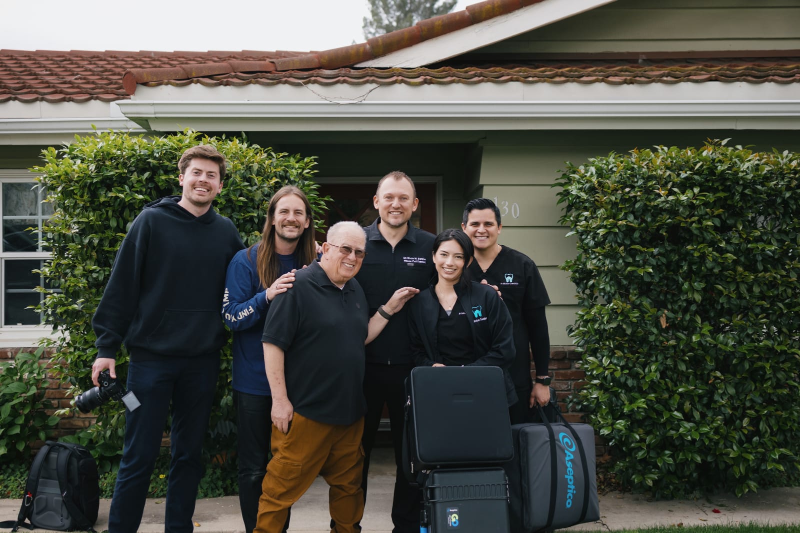 The In Motion Dentists team smiling together outside their La Verne dental office.