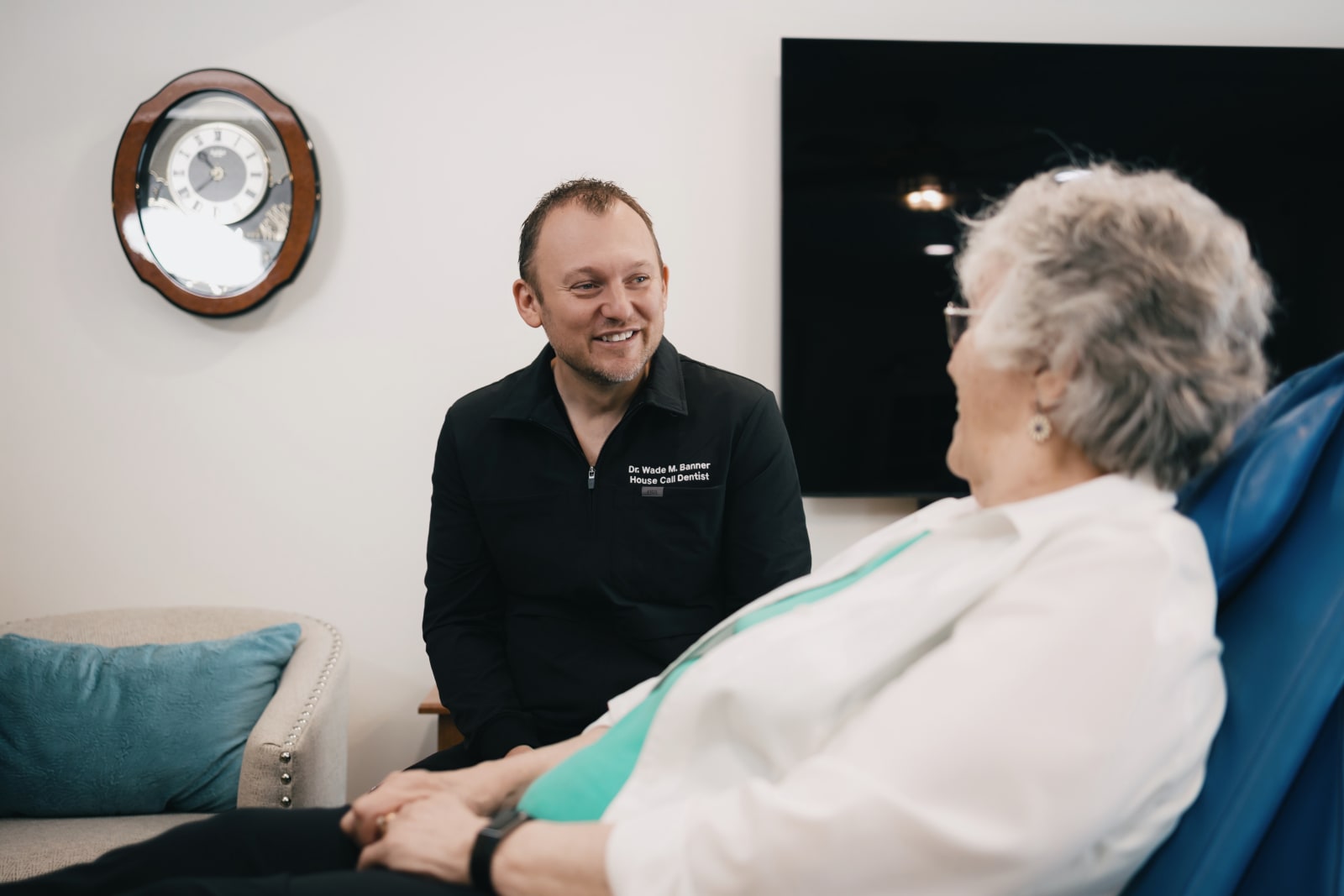 Dentist consulting with patient about dental procedure in treatment room